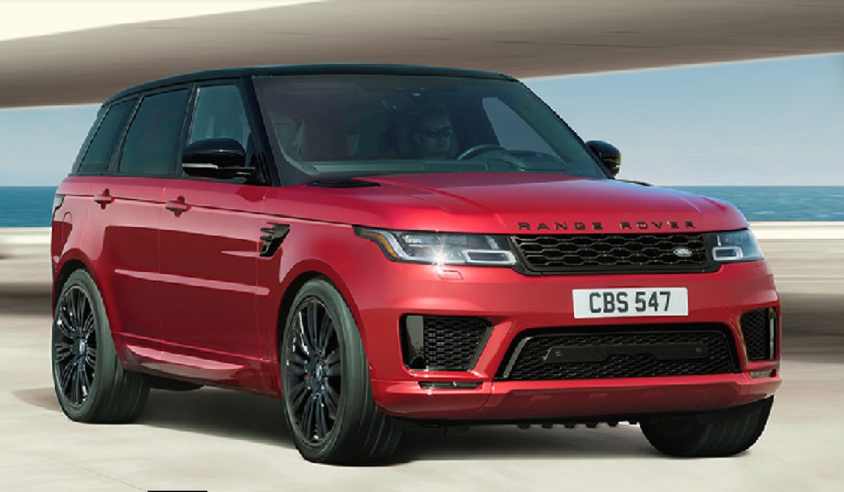 A red 2022 Land Rover Range Rover Sport parked in front of the ocean.