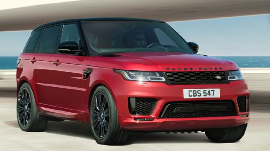 A red 2022 Land Rover Range Rover Sport parked in front of the ocean.