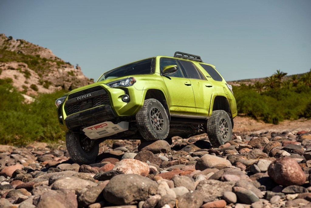 2022 Toyota 4Runner TRD Pro in Lime paint color option driving off-road on rocks