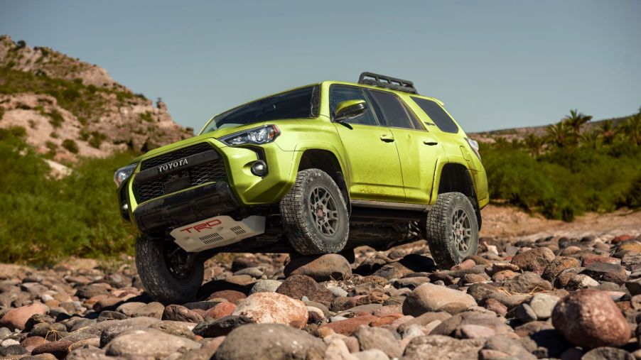2022 Toyota 4Runner TRD Pro in Lime paint color option driving off-road on rocks