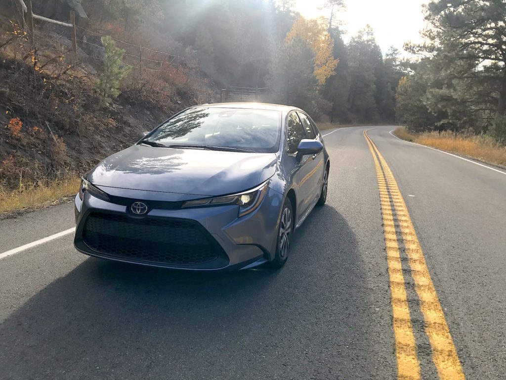 A front shot of the 2022 Toyota Corolla Hybrid driving down the road for our full review.