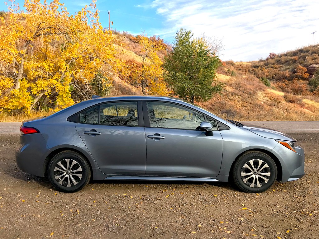 A side shot of the 2022 Toyota Corolla Hybrid in the woods