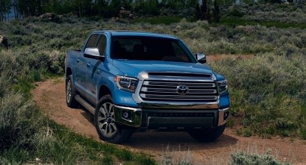 A blue 2022 Toyota Tundra is driving on a trail.
