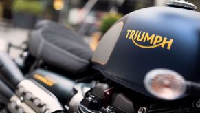 A close-up view of the 2022 Triumph Street Scrambler Gold Line's blue-silver-and-gold fuel tank