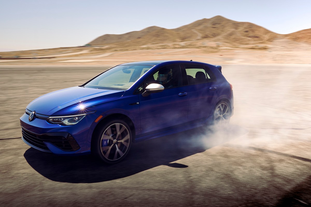 2022 Volkswagen Golf R Mk 8 in blue drifting away from the camera. A car similar to this is featured in the drag race video in this article