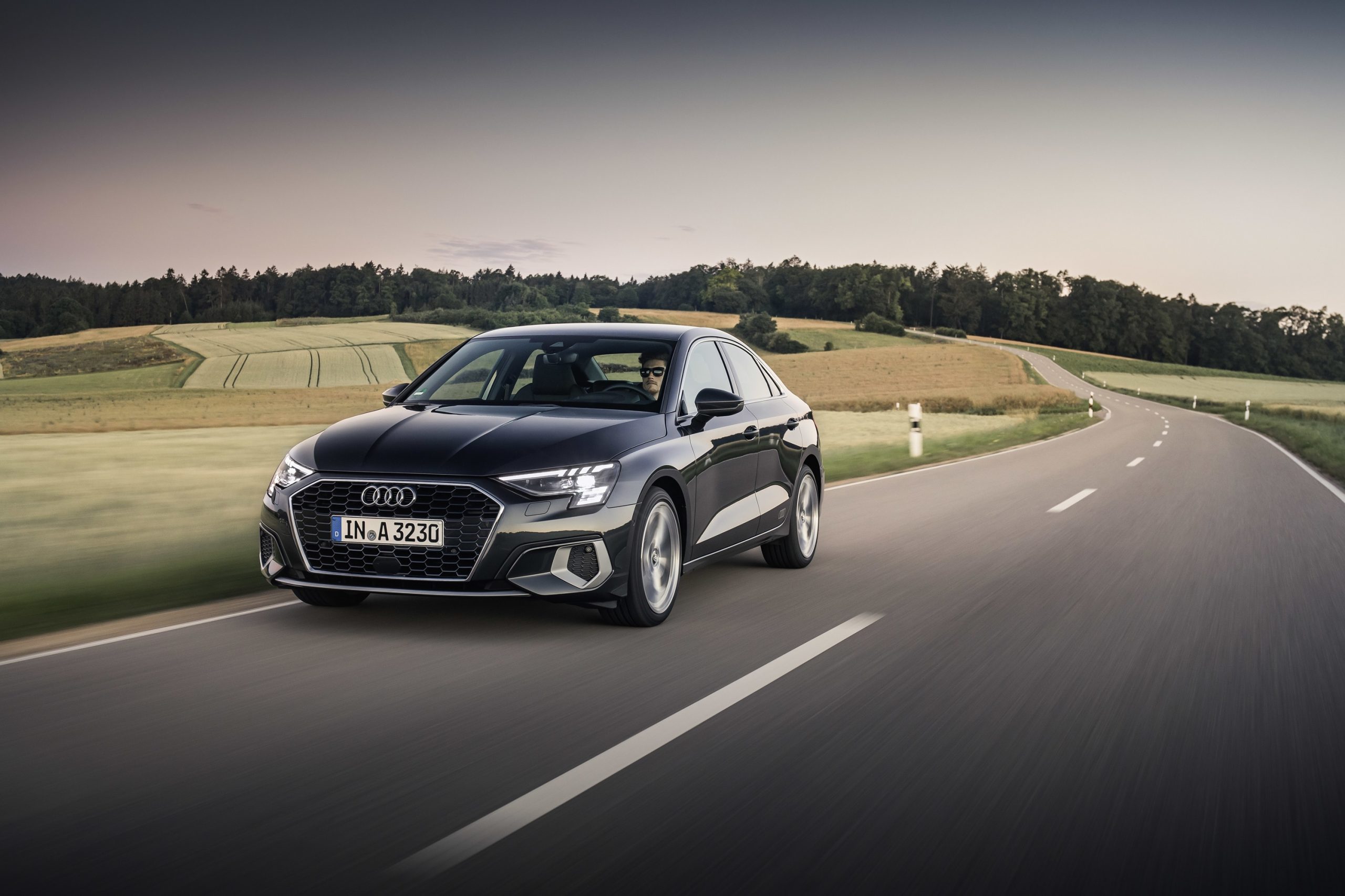 The 2022 Audi A3 in grey on a country road, shot from the 3/4 angle