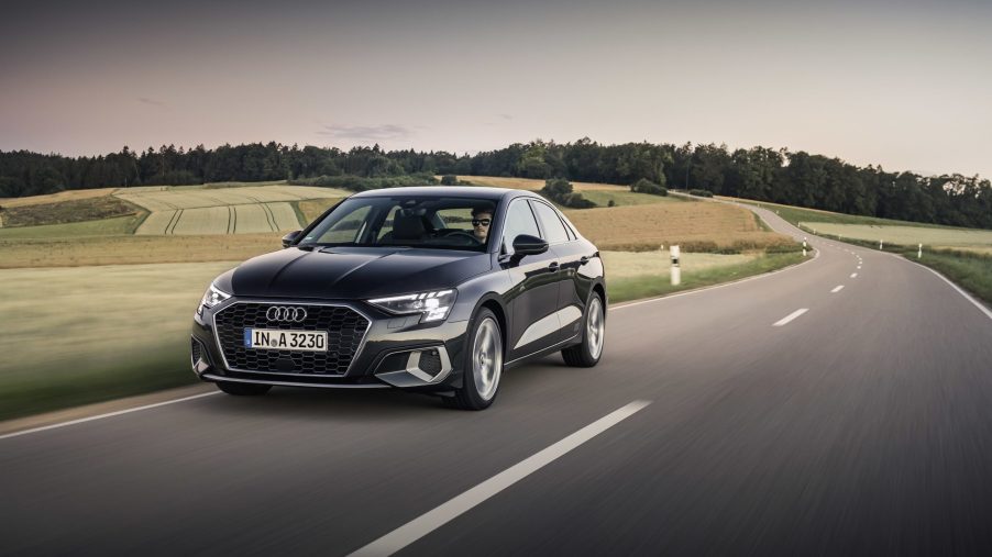 The 2022 Audi A3 in grey on a country road, shot from the 3/4 angle