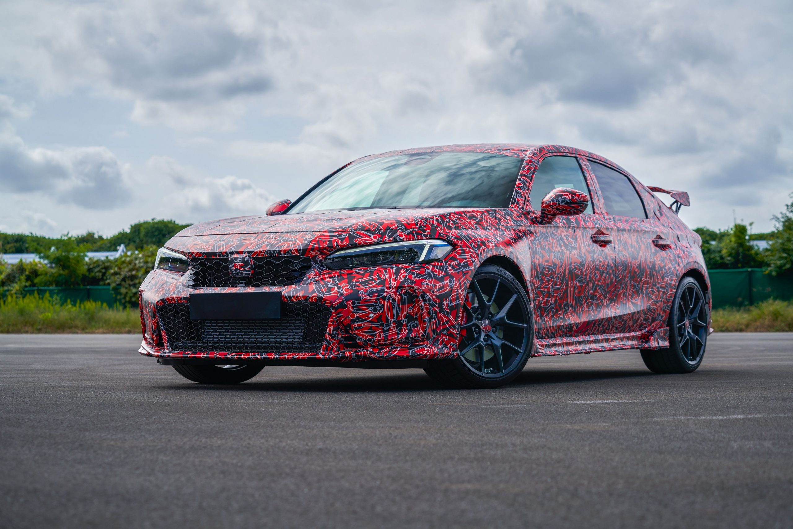 The 2022 Honda Civic Type R with red camo livery shot from the front 3/4