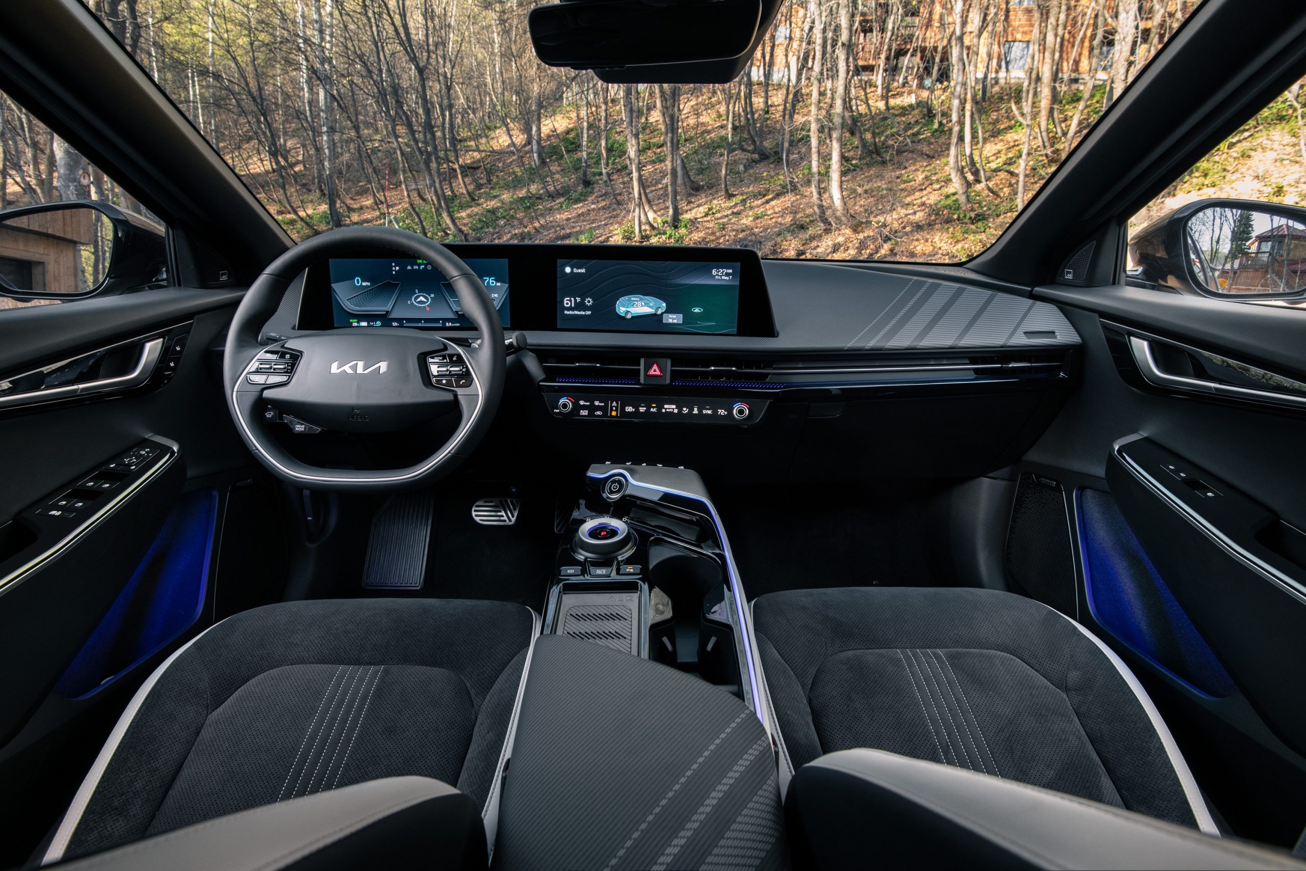 The interior of the EV6, with black alcantara and leather seats and a two-spoke steering wheel