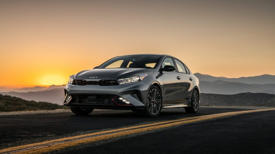 The 2022 Kia Forte GT shot at sunset on a mountain road from the front 3/4 angle
