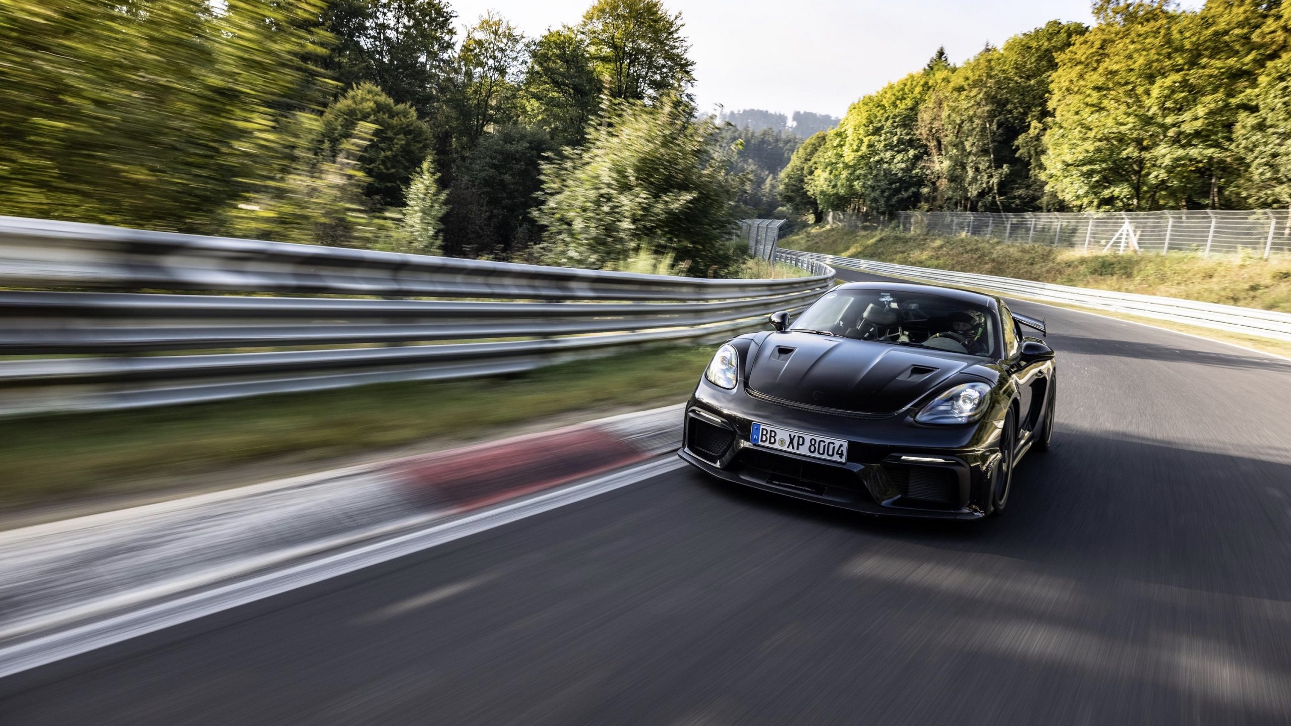 A black Porsche Cayman GT4 RS at the Nurburgring, shot from the front 3/4