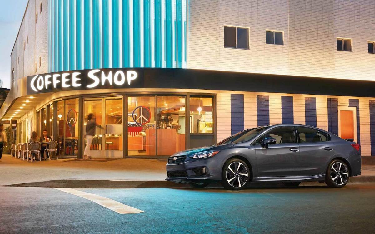 2022 Subaru Impreza brand new sedan parked outside of a coffee shop