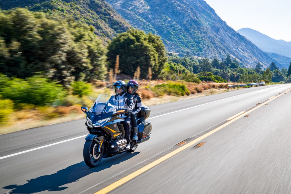 A couple on a Honda Gold Wing Tour DCT traveling on the highway