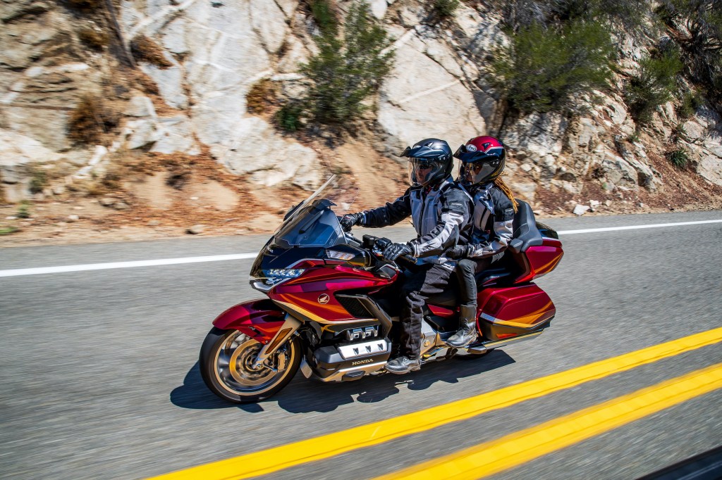 a couple riding a Honda Gold Wing Tour in Candy Ardent Red |
