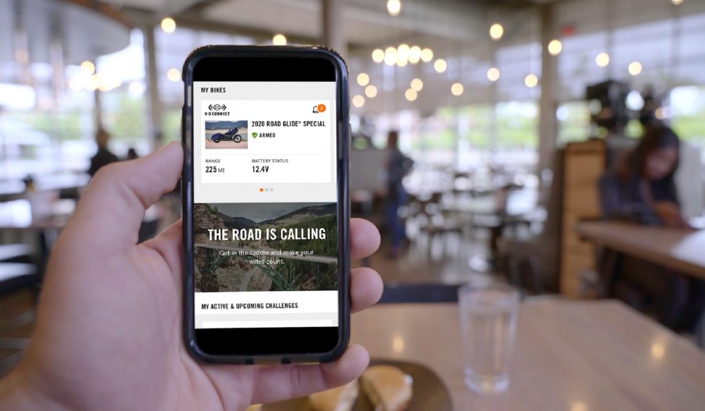 A 2020 Harley-Davidson Road Glide Special motorcycle rider accessessing the Harley-Davidson App on their smartphone