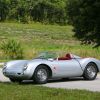 A silver-with-red-badging Beck 550 Spyder Replica by Chamonix Karosserie on a country road