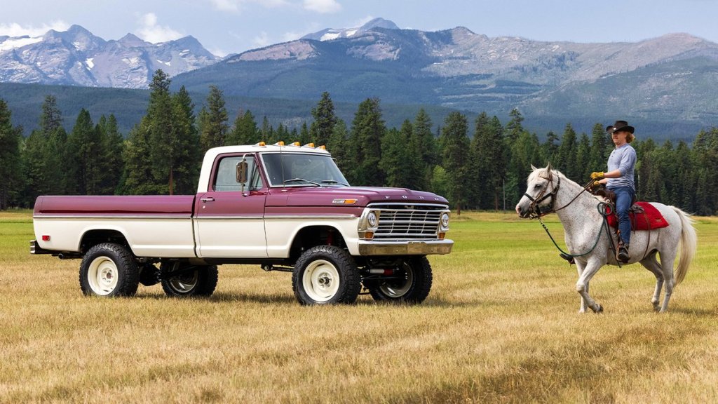 A man riding a horse by a vintage 1969 Ford F-100 truck