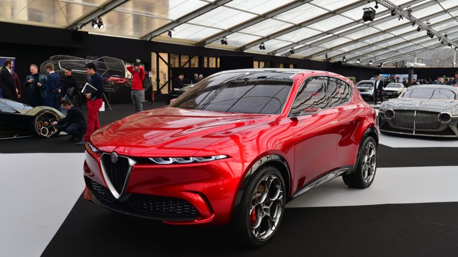A red Alfa Romeo Tonale concept model displayed at the Paris Festival Automobile International with concept cars and automotive design exhibition.