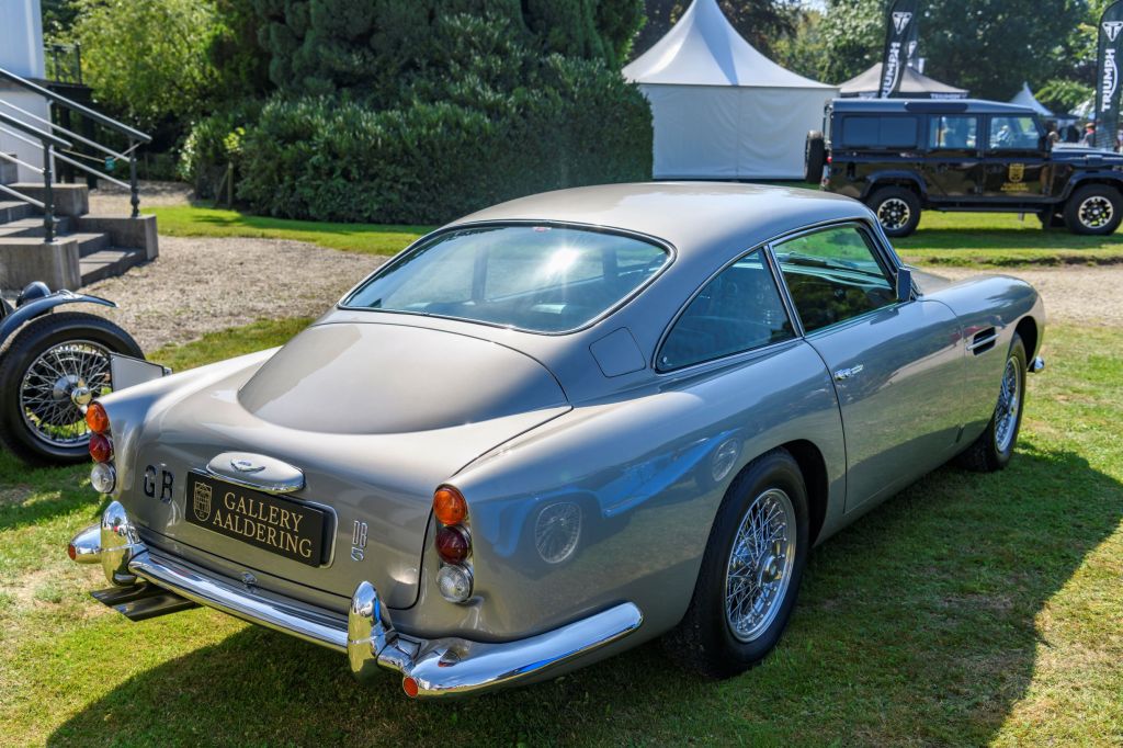 The rear 3/4 view of a silver original Aston Martin DB5 at the 2019 Concours d'Elegance