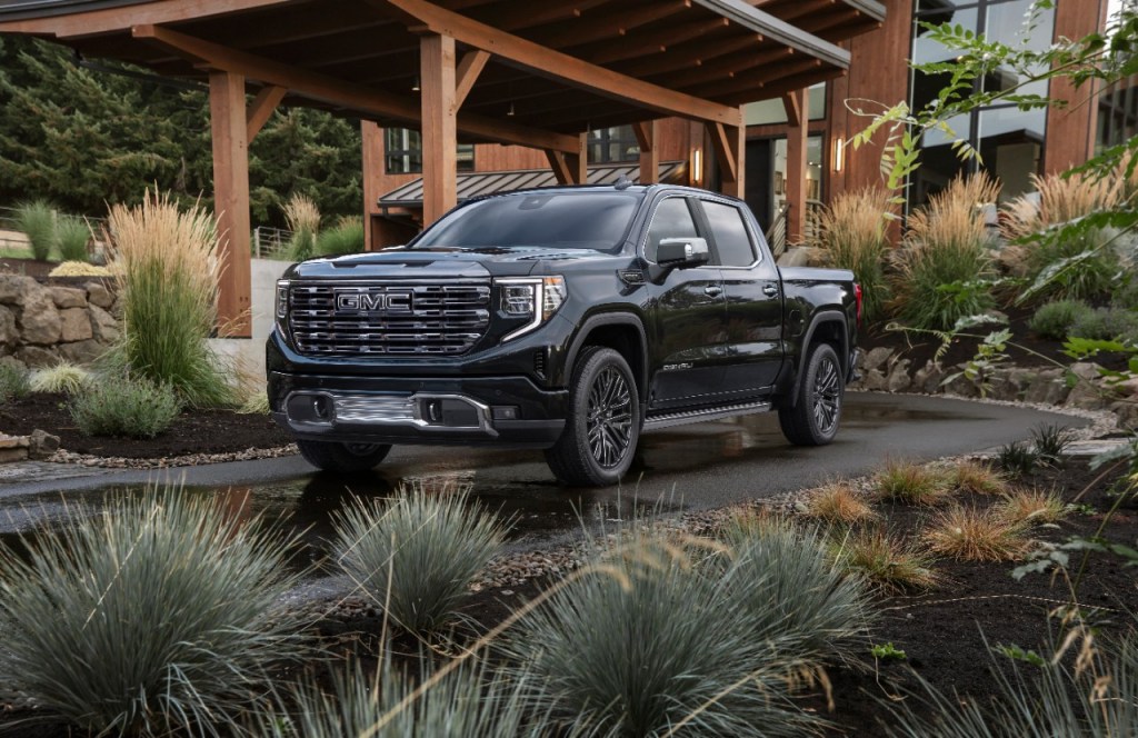 Black 2022 GMC Sierra 1500 Denali Ultimate parked in front of a house, could it be better than the Ram 1500 off-road?