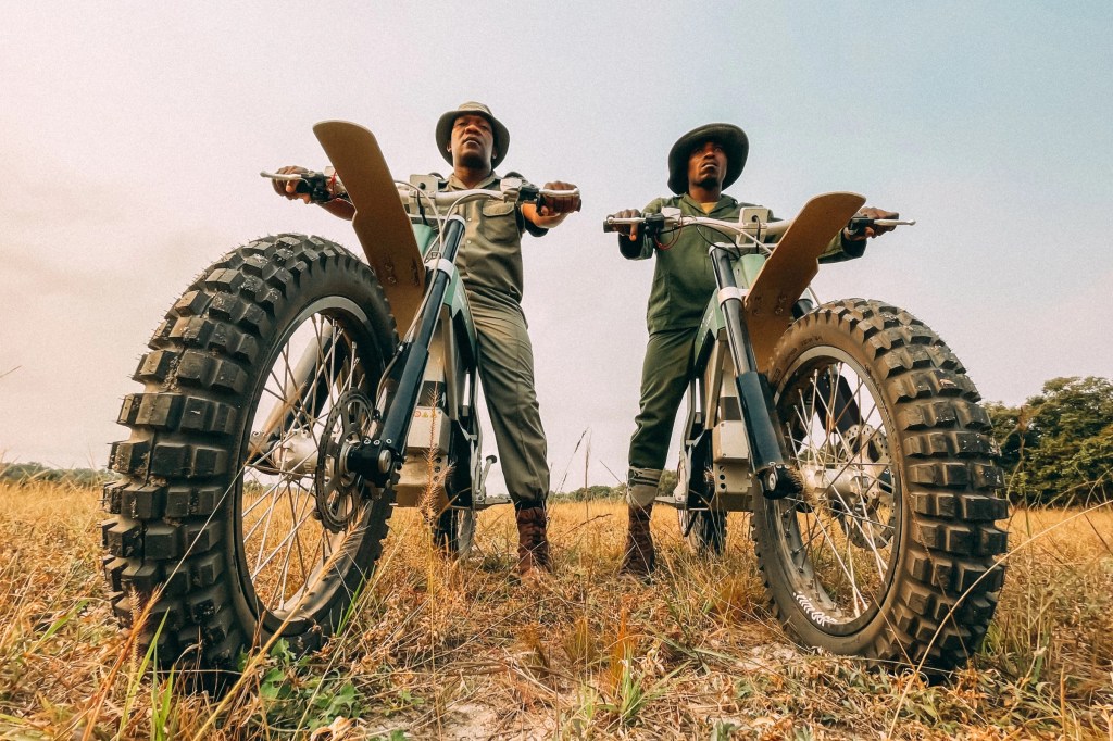 two Rangers sitting on their CAKE Kalk AP electric dirt bikes wating to bust some poachers in Africa