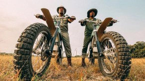 two Rangers sitting on their CAKE Kalk AP electric dirt bikes wating to bust some poachers in Africa