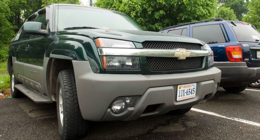 A green Chevrolet Avalanche in a commuter parking lot in Warrenton, Va.