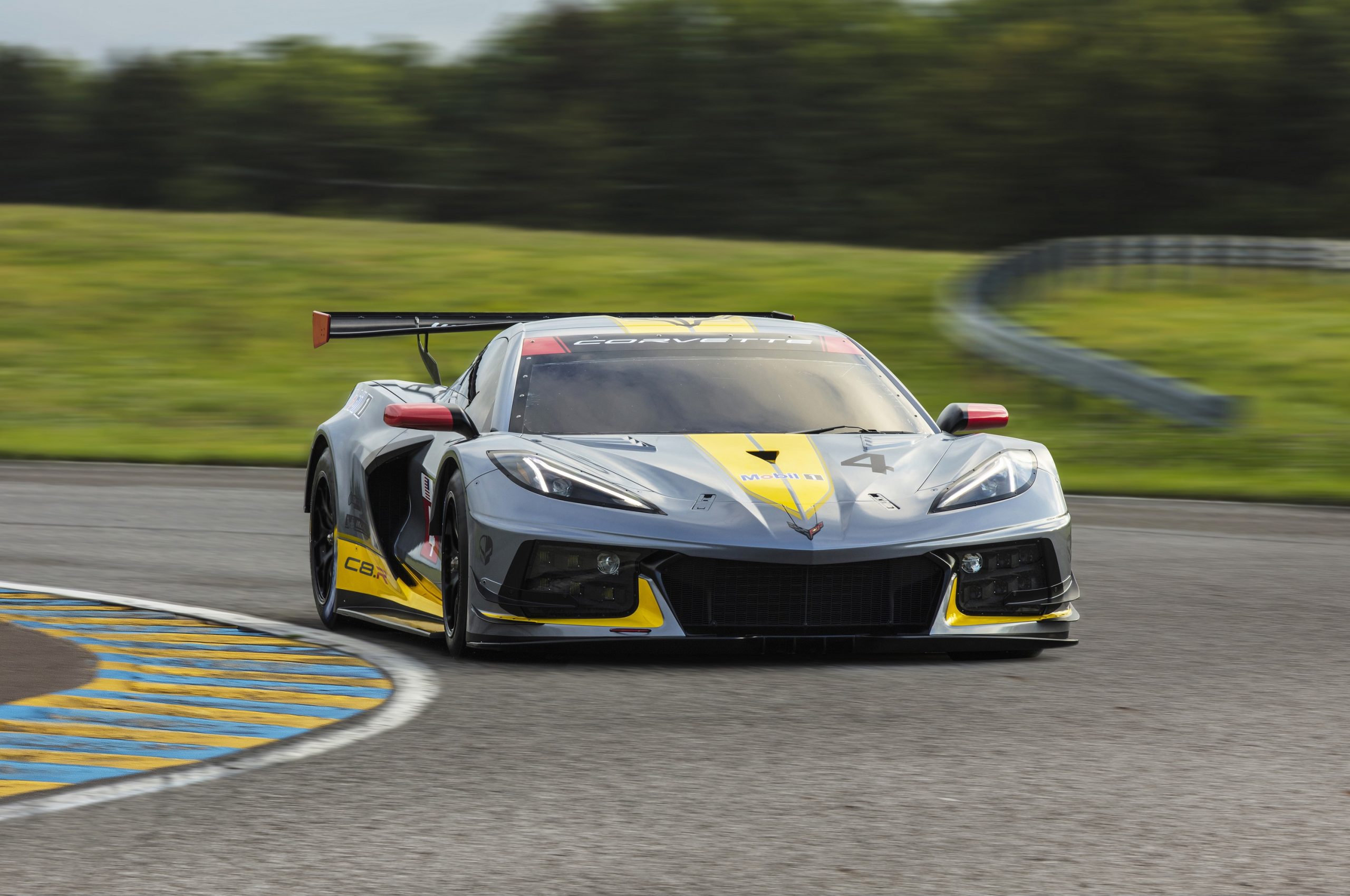 The grey and yellow Chevrolet C8.R racing car on track shot from the 3/4 angle
