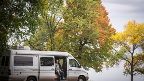 Class B Camper Van Parked In Woods. What's the average cost of a camper van like this one. BUt there are still some hidden RV costs that need to planned for.