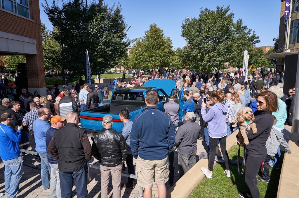 Crowd of people gathered around a blue Rivian R1T in Normal, Illinois