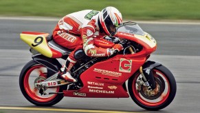 A rider racing a red-and-yellow Ducati Supermono
