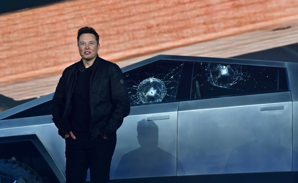 Elon Musk standing in front of Telsa Cybertruck