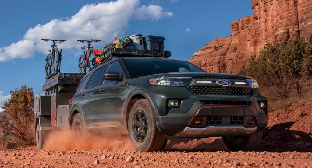 A black Ford Explorer Timberline is carrying a load and off-roading. 