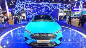 A 2021 blue Ford Mustang Mach-E. is n display.