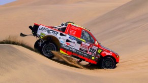 A red Ford Raptor RS Cross Country car driven by Tomas Ourednicek of The Czech Republic and David Kripal of The Czech Republic compete in the desert during Stage Two of the 2019 Dakar Rally between Pisco and San Juan de Marcona on January 7, 2019 in Pisco, Peru.