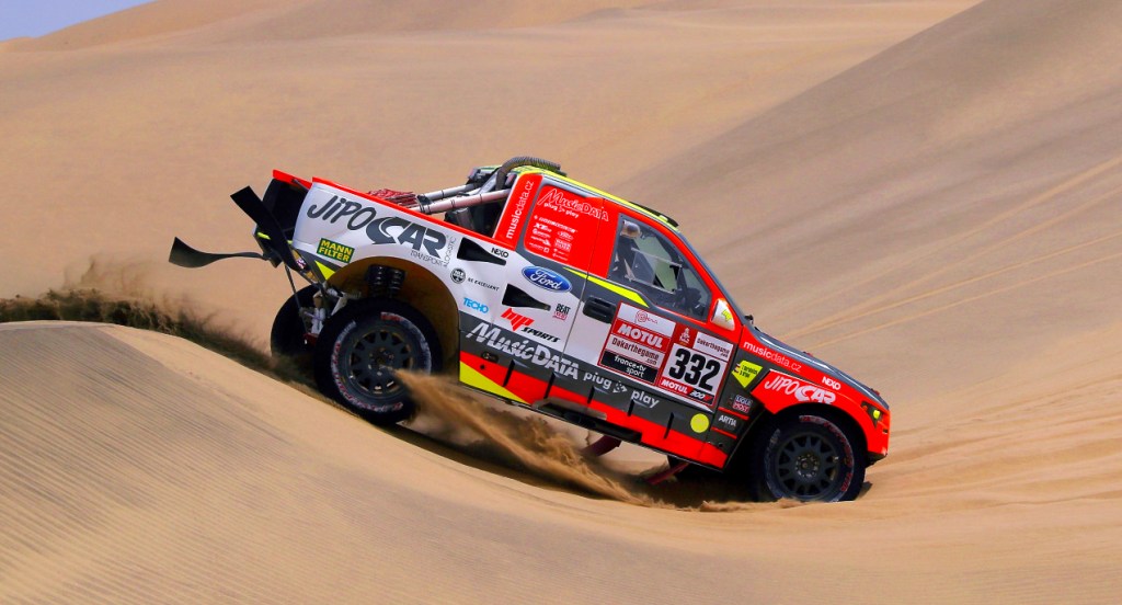 A red Ford Raptor RS Cross Country car driven by Tomas Ourednicek of The Czech Republic and David Kripal of The Czech Republic compete in the desert during Stage Two of the 2019 Dakar Rally between Pisco and San Juan de Marcona on January 7, 2019 in Pisco, Peru.
