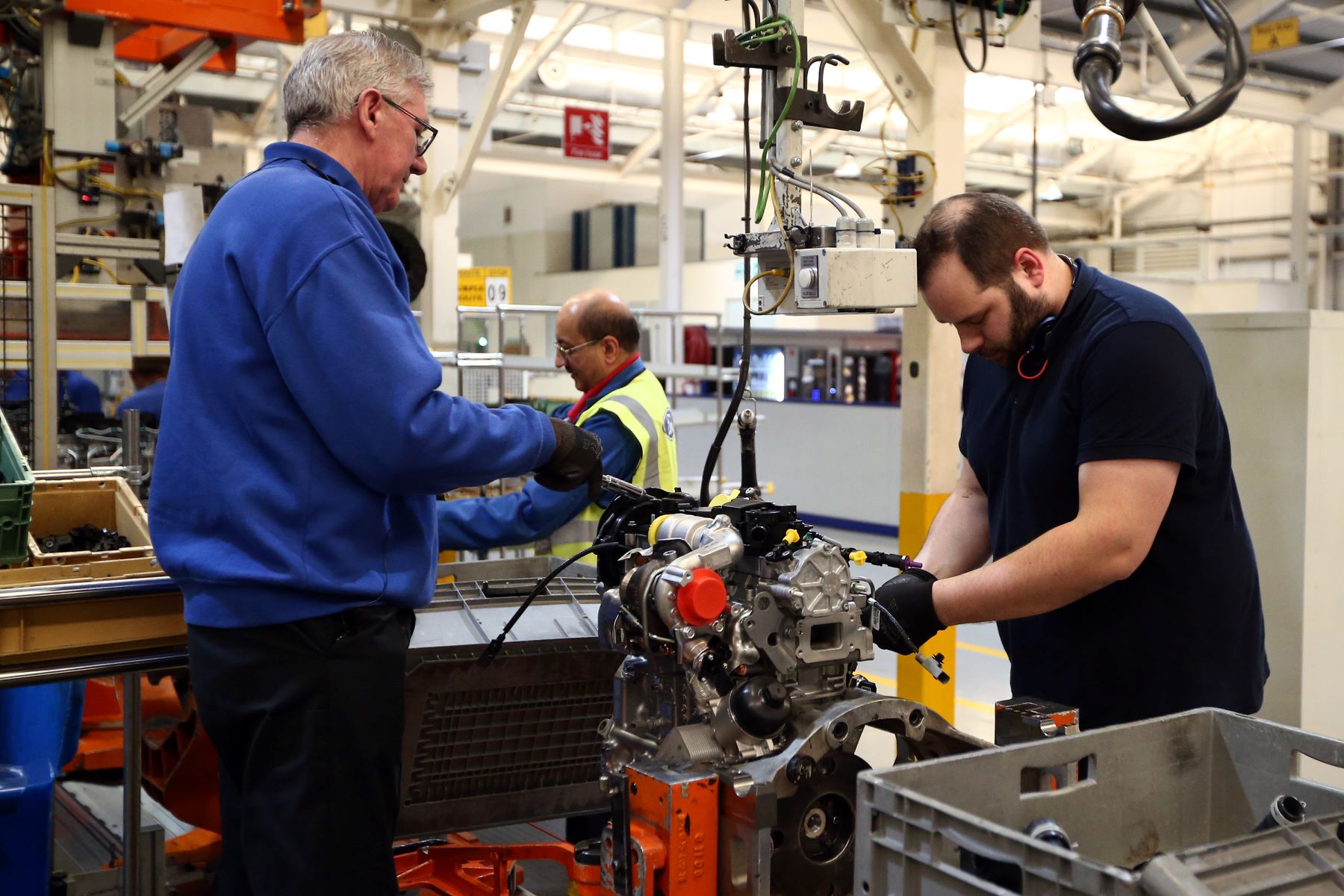 Ford employees working on a diesel engine at a factory in Dagenham, England