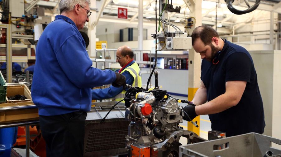 Ford employees working on a diesel engine at a factory in Dagenham, England