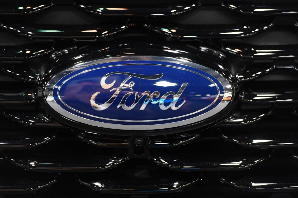 Blue and chrome Ford logo on a black grille.