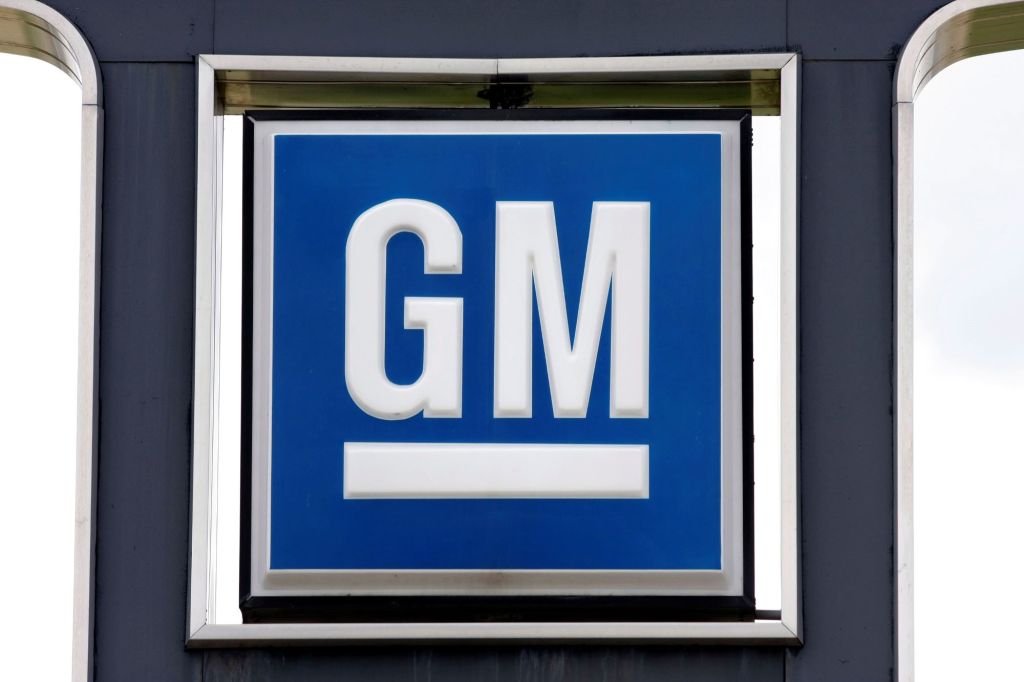 GM logo on a sign against a white background framed with black