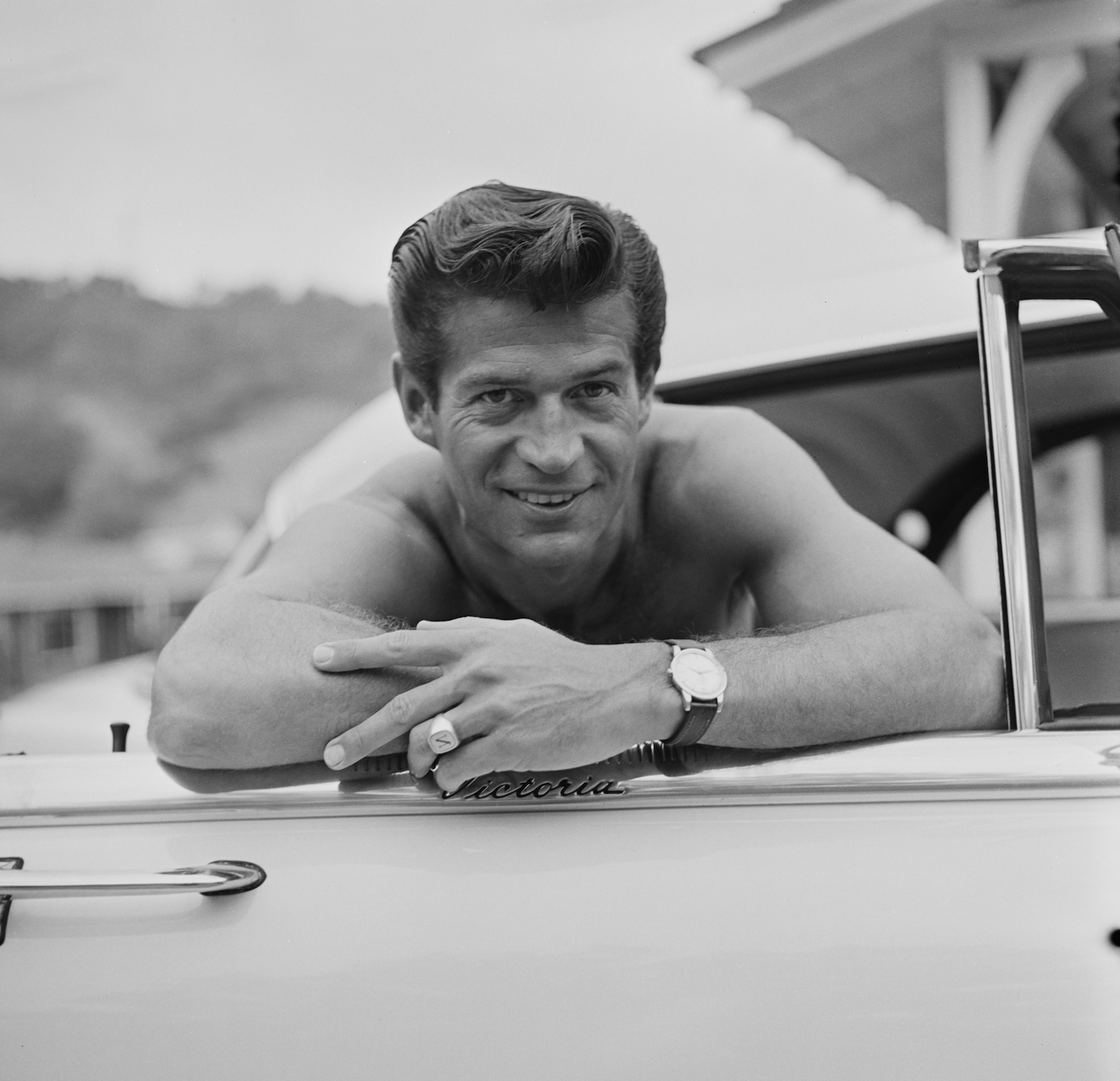 Actor George Nader poses shirtless in his Ford Victoria convertible in 1955. Traffic laws do not dictate drivers' outfits. Penal laws do. Driving shirtless is not illegal wherever being shirtless in public is legal. Drivers are not exempt from public decency and indecent exposure laws. | Graphic House/Archive Photos/Getty Images