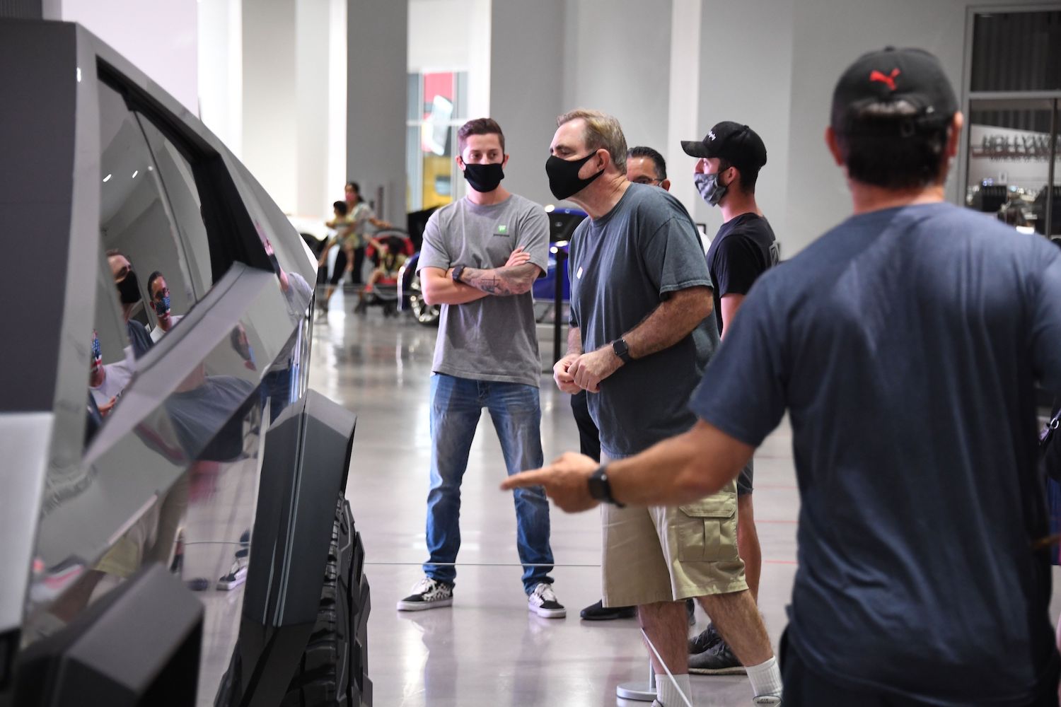 Tesla fans visit the first gen Cybertruck prototype at a museum. The startup has added traditional Cybertruck mirrors to their upcoming electric pickup. | ROBYN BECK/AFP via Getty Images