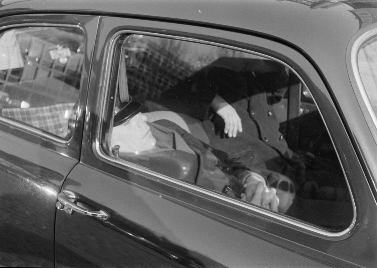This is a photo of a man sleeping in a Volkswagen Beetle. Sleeping in your car is legal unless prohibited by local laws. | Erich Andres/United Images via Getty Images