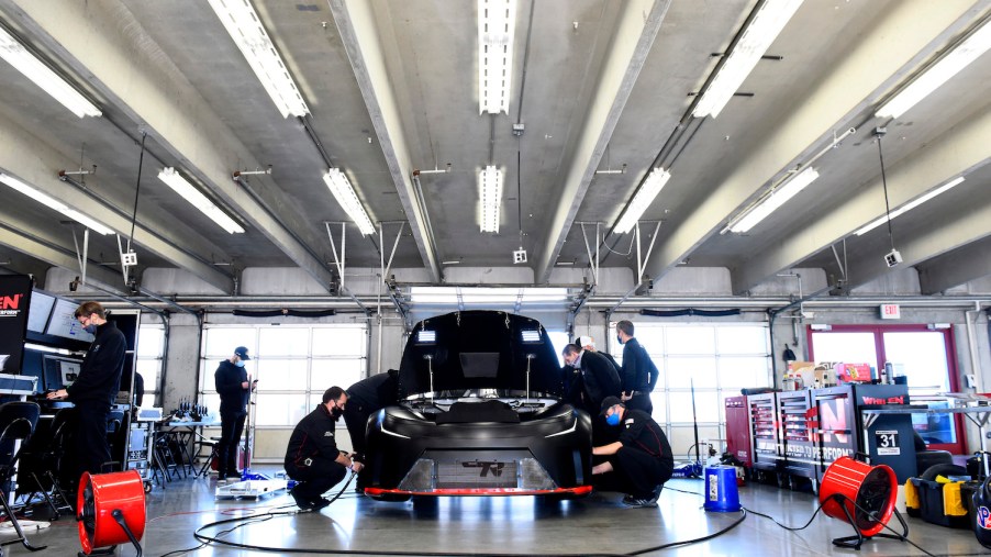 These are NASCAR team members trying to cool down the Next Gen prototype. The NASCAR Next Gen car is in the garage in North Carolina. | Jared C. Tilton/Getty Images