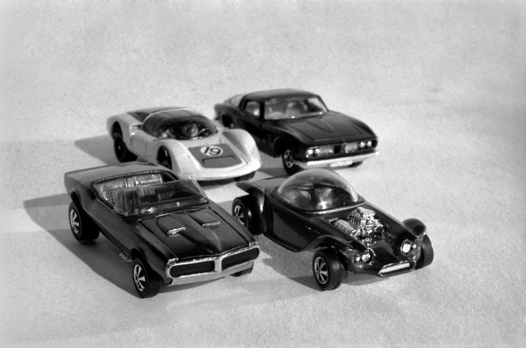 a black and white photo of a few toy cars. It's hard to believe the most expensive Hot Wheels Cars can be this small and silly.