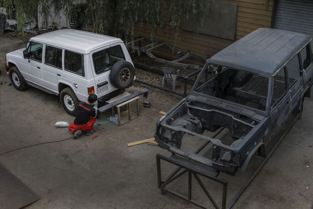 A mechanic restores a vintage Hyundai SUV. SUV stands for sport utility vehicle. The difference between and SUV and a crossover (CUV means crossover utility vehicle) comes down to the vehicle's construction. Both styles are available with 4WD and extra cargo space. | Seung-il Ryu/NurPhoto via Getty Images