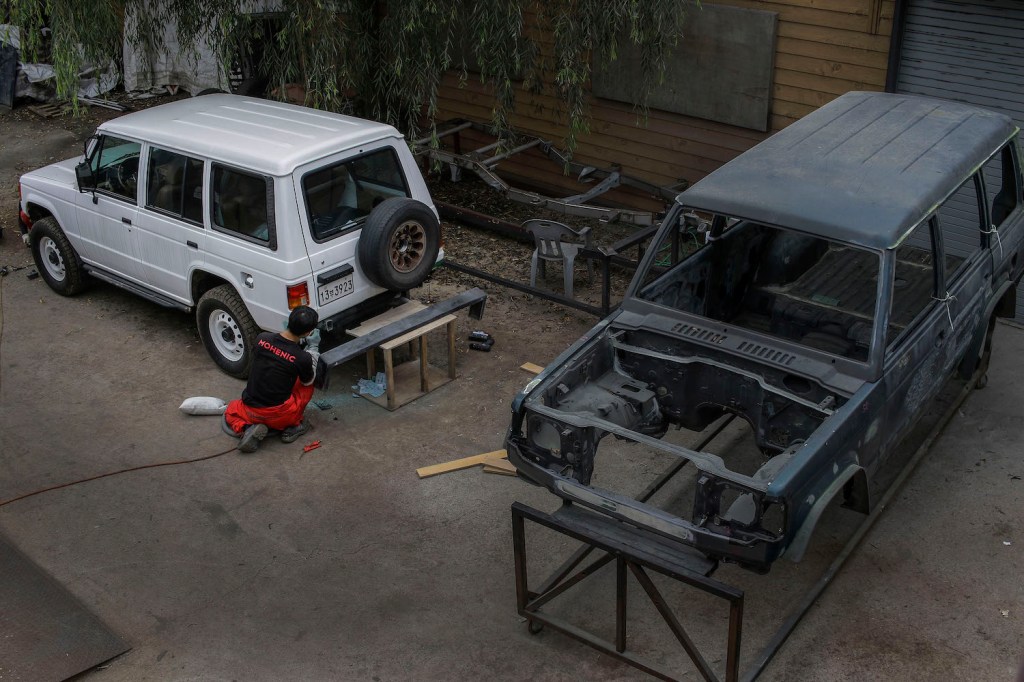 A mechanic restores a vintage Hyundai SUV. SUV stands for sport utility vehicle. The difference between and SUV and a crossover (CUV means crossover utility vehicle) comes down to the vehicle's construction. Both styles are available with 4WD and extra cargo space. | Seung-il Ryu/NurPhoto via Getty Images