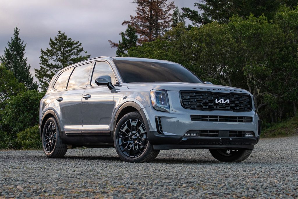 Gray 2022 Kia Telluride parked in front of a forest