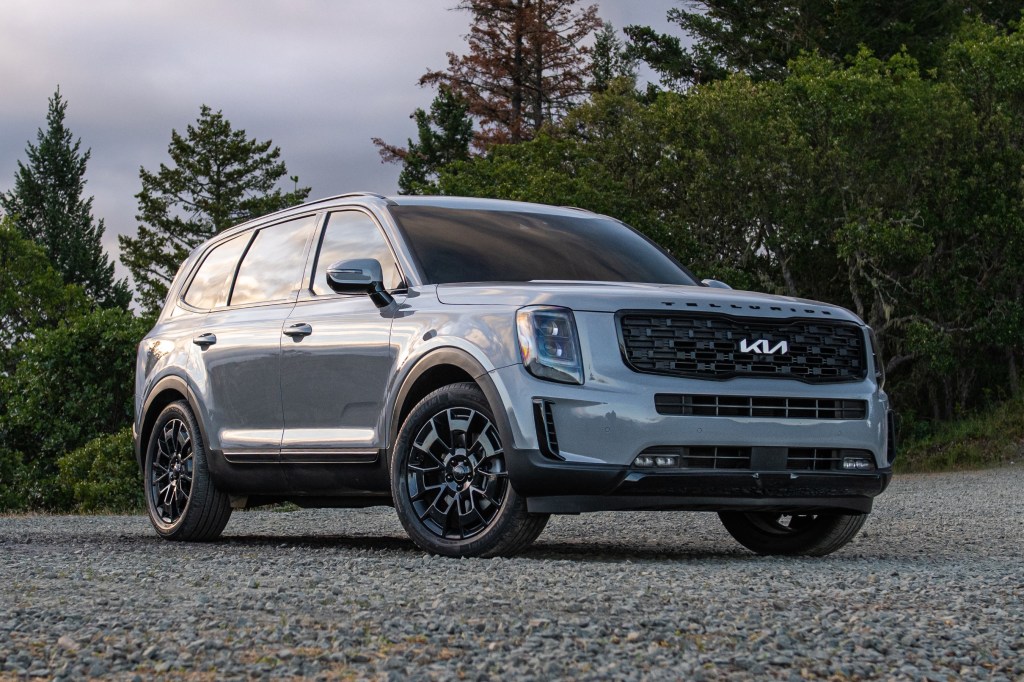 Everlasting Silver 2022 Kia Telluride midsize SUV parked in front of a forest