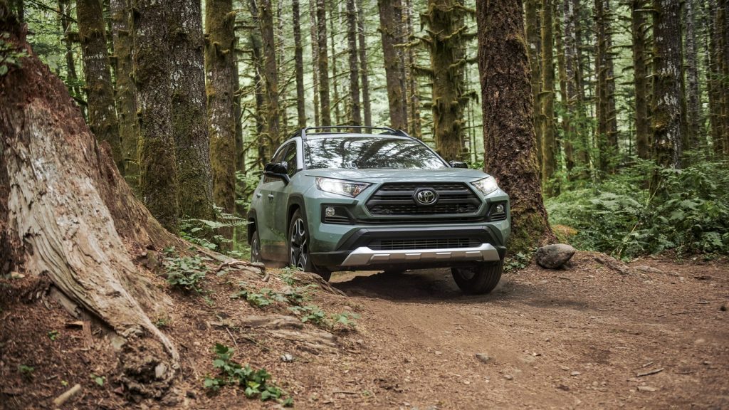 2022 Toyota RAV4 with Lunar Rock exterior paint color option driving through a forest